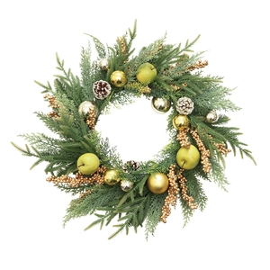 Artificial Christmas wreath with pine branches, gold ornaments, pinecones and green apples