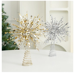 Close-up of champagne gold and silver star tree toppers with sparkling glitter finish