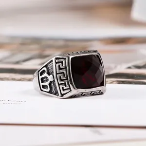 Vintage silver-tone titanium steel men's ring with a faceted garnet-red gemstone