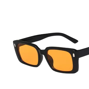 Retro square black sunglasses with orange lenses and silver rivets on white background