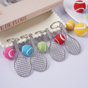 Miniature tennis racket and colorful ball keychain set in decorative tray display