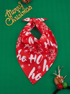 Detail view of red Christmas pet bandana with Ho Ho Ho text and snowflake patterns