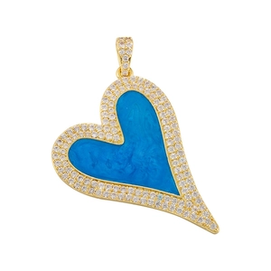 Golden heart pendant with blue marble enamel and sparkling zircon stones on white background