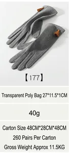 Detail of gray winter thermal gloves with brown tassels and touchscreen fingertip feature