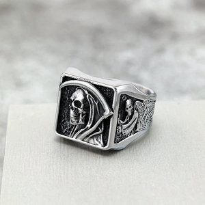 Vintage stainless steel punk ring featuring detailed grim reaper and winged skull relief