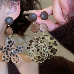 Leopard print resin flower and circular drop earrings with vintage wood texture accents