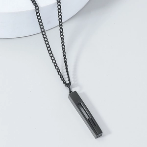 Close-up of black stainless steel pillar pendant necklace on a white display stand