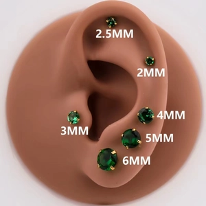 Macro view of green zircon stud earrings in six sizes from 2mm to 6mm on ear model