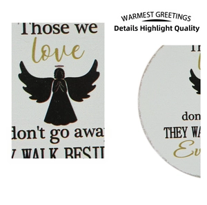Macro detail of wooden memorial plaque featuring angel silhouette and commemorative poetry