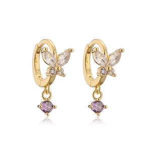 Close-up of gold butterfly hoop earrings featuring colorful cubic zirconia and purple drop