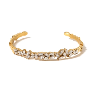 Minimalist gold open cuff bracelet featuring elegant rectangular zircon stones on white background