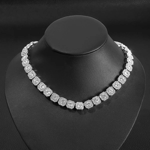 Macro detail of silver alloy Cuban chain necklace with sparkling square blue sapphire