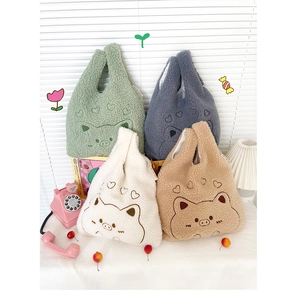 Close-up of plush wrist bags with cute animal embroidery and lamb wool texture