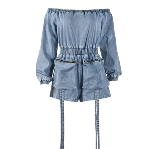 Detail of light blue denim romper with off-shoulder neckline and functional zip pockets