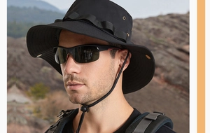 Detail of black wide brim boonie hat featuring side vents and tactical strap for outdoors