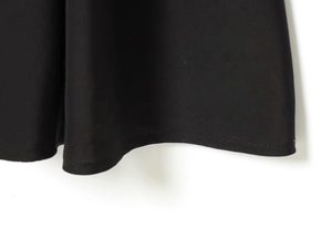 Macro detail of the high-quality stitching and plain weave fabric hem on this black dress