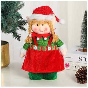 Close-up of a plush Christmas elf doll with red hat and green dress in a festive setting