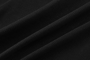 Detail of breathable black mesh fabric with honeycomb texture for a slim fit dress