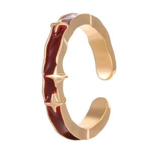 Detailed view of the gold adjustable ring with red enamel inlay and tiny star accents