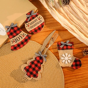 Christmas plaid cutlery holders with Merry Christmas embroidery on a rustic wooden table