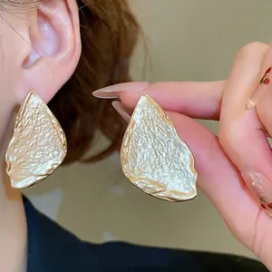 Golden irregular geometric leaf earrings with hammer texture for a minimalist style
