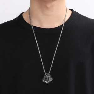 Detailed view of punk plague doctor pendant in silver finish worn on neck chain
