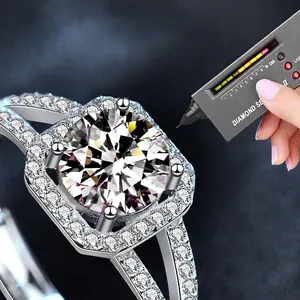 Square 925 silver moissanite ring with halo setting being tested by diamond selector