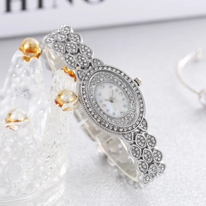 Luxury silver ladies quartz watch with oval crystal-set dial on a crown display