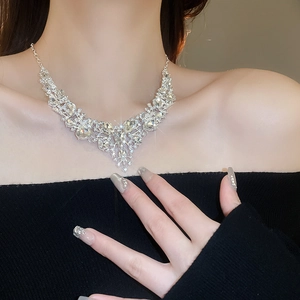 Detailed view of silver rhinestone drop necklace on model for evening dress styling