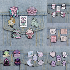 Purple Halloween magic cat and witch tombstone enamel pins set on denim jacket