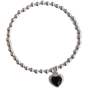 French vintage silver beaded bracelet with a black heart pendant on a white background