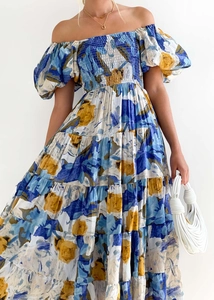 Detailed macro view showing elastic shirring on blue floral off-shoulder puff sleeve dress