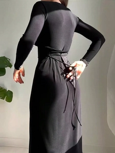 Elegant black V-neck dress featuring an open back with adjustable drawstring tie details
