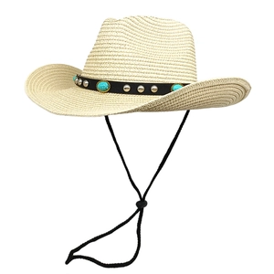 Close-up of beige straw cowboy hat with turquoise stone and silver stud band details