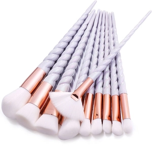 Detailed view of unicorn spiral handles and rose gold ferrules on 10pc makeup brush set