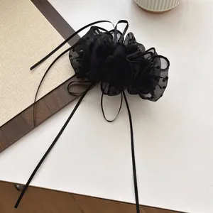 Elegant black polka dot tulle hair clip with long ribbons for a chic French vintage look