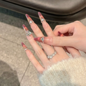 Pomegranate wine cat-eye stiletto fake nails with sparkling rhinestones and heart gems
