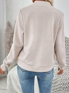Detail of pink long-sleeve jacket showing 3D geometric texture and back silhouette