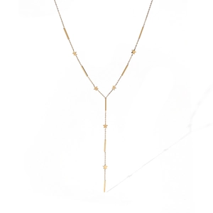Detail shot of a 18K gold-plated Y-shaped necklace with star and long bar pendants