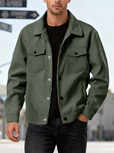 Detail of army green corduroy jacket showing textured fabric and button chest pockets