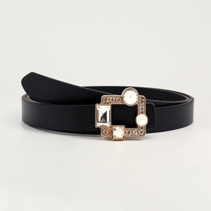 Close-up of black PU leather belt featuring a gold buckle with inlaid crystals