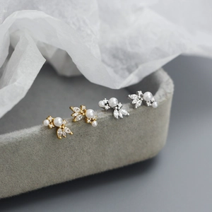 Macro shot of elegant floral pearl earrings with marquise zircons in a jewelry box