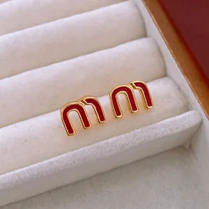 Elegant gold-plated M-shaped stud earrings with glossy red enamel finish for women