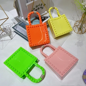 Mini PVC jelly handbags with stud details in orange yellow green and pink colors