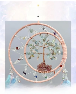 Detail of dream catcher with life tree crystal stones and colorful hanging feathers