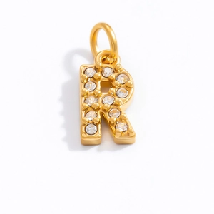 Detailed view of 18K gold plated letter R pendant with sparkling cubic zirconia inlay