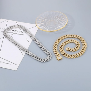 Detailed close-up of gold and silver hip-hop Cuban link chains with iced-out micro-pave diamonds