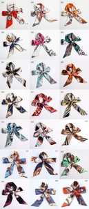 Grid view of 21 silk ribbon scarves in various vintage prints and equestrian patterns