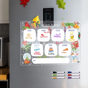 Detail of magnetic acrylic weekly planner with Christmas graphics and 6 markers on fridge