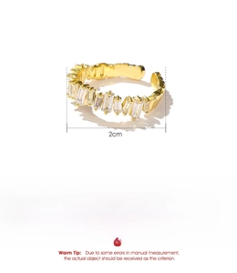 Detailed view of golden copper ring with cubic zirconia stones and product dimensions